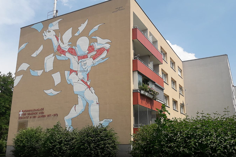 Darstellung eines Graffitis und Streetart auf einer Gemeindebau-Wand